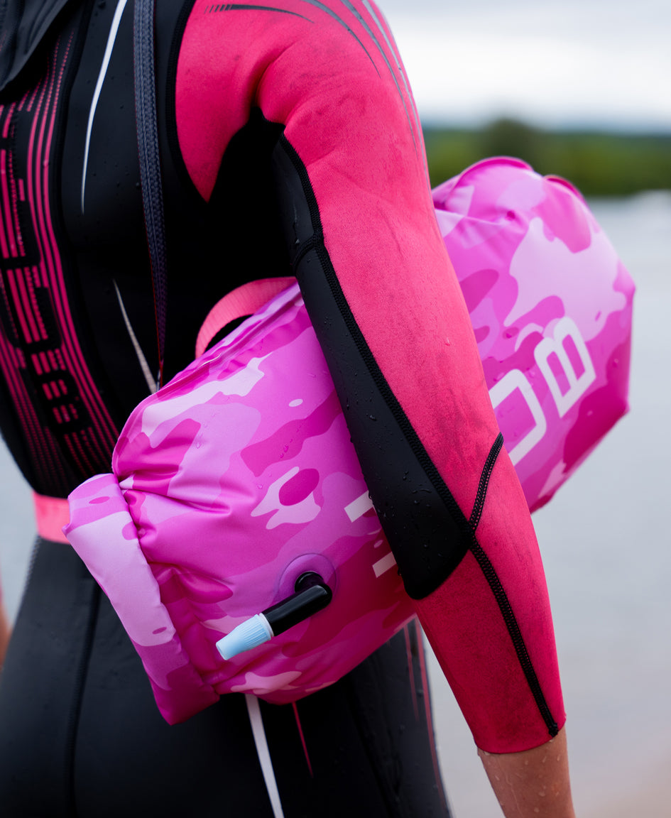 Pink Camo HUUB tow float showing dry-bag style compartment and leash attachment