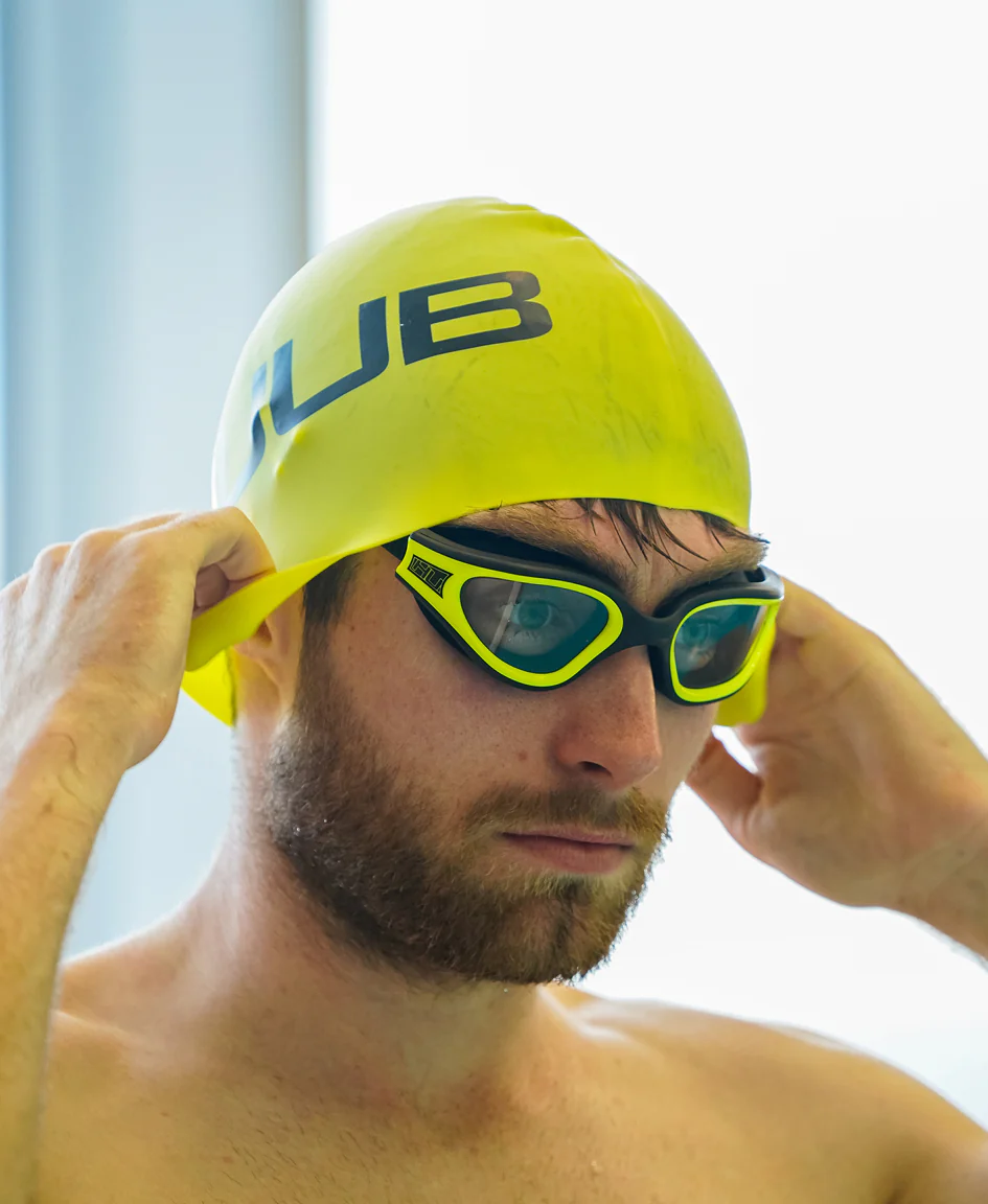 Bright orange HUUB silicone swim cap with a smooth, snug fit perfect for competitive swimming or training.