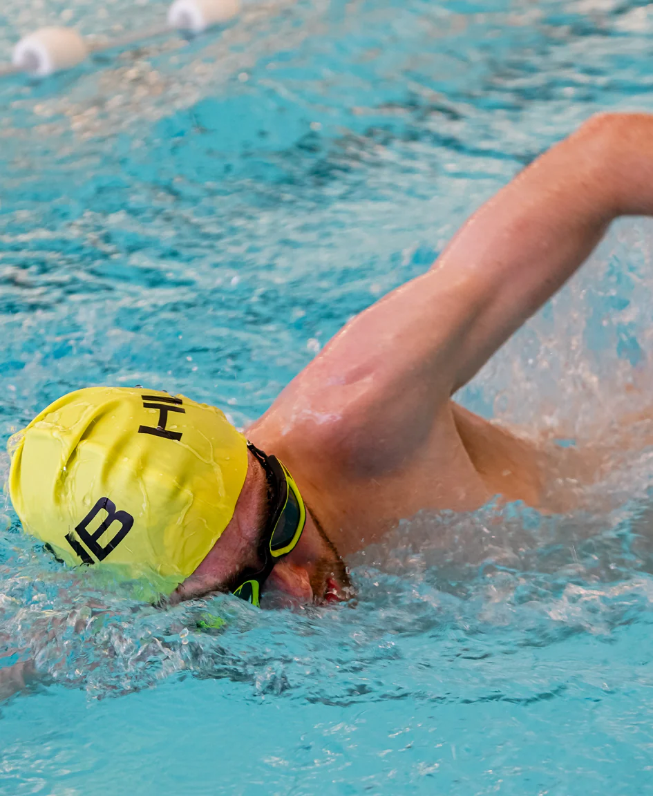 Bright orange HUUB silicone swim cap with a smooth, snug fit designed for comfortable swimming protection.