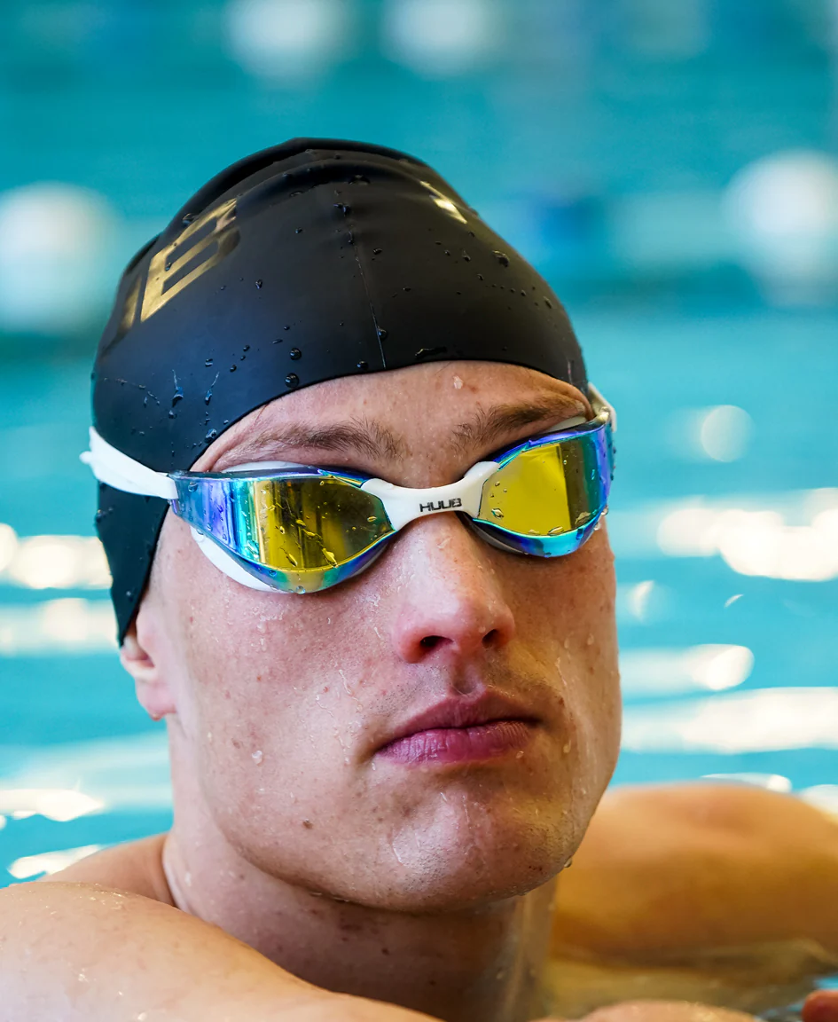 Bright orange HUUB silicone swim cap with a smooth, snug fit for comfortable swimming and water resistance.