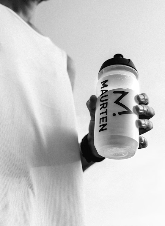 500 ml Maurten sports bottle with a clear plastic body and green lid, designed for hydration during athletic activities.