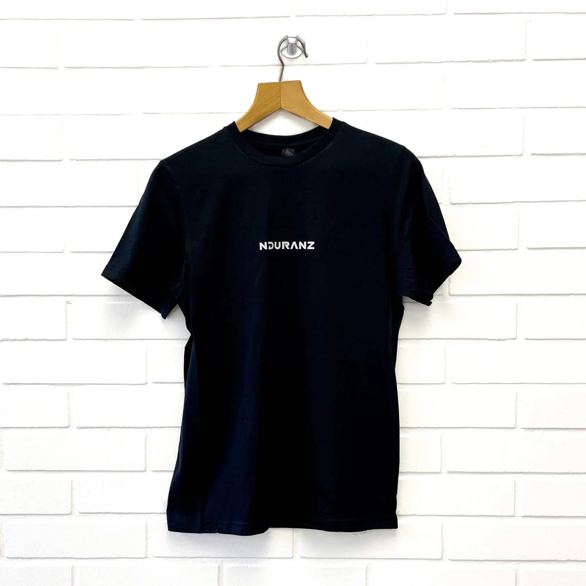 Nduranz T-shirt in black with round neckline and short sleeves, casual fit, displayed on a hanger.
