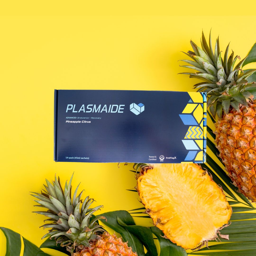 Single-serve Plasmaide Pineapple Citrus beverage in a clear glass, showcasing fresh pineapple and citrus slices.